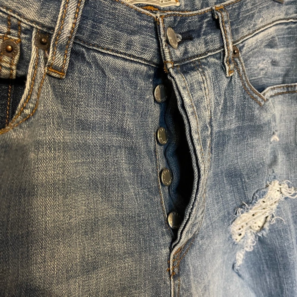 Free People distressed jeans w/crocheted patches